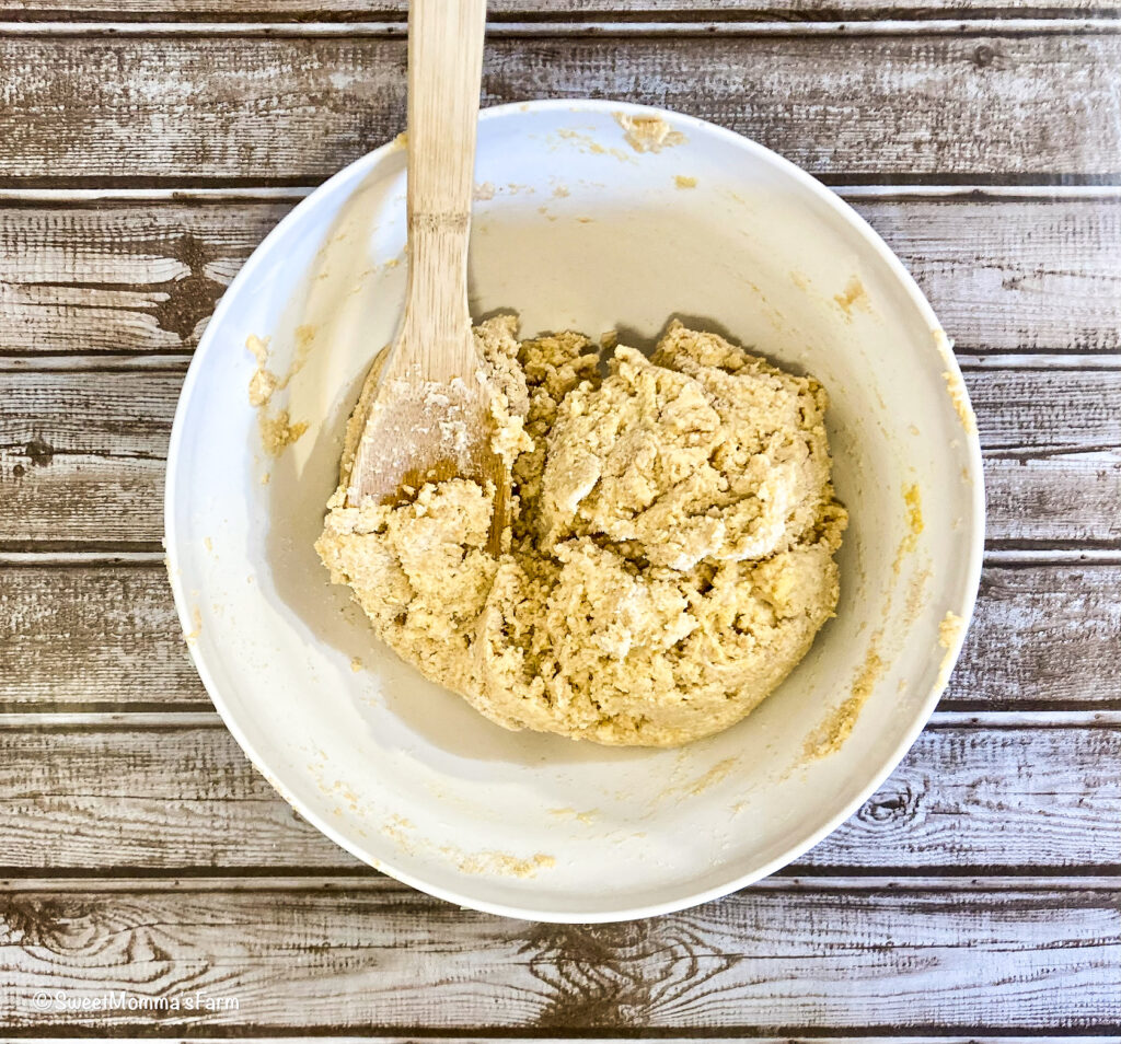 Biscuit dough all mixed together in a bowl with a spoon