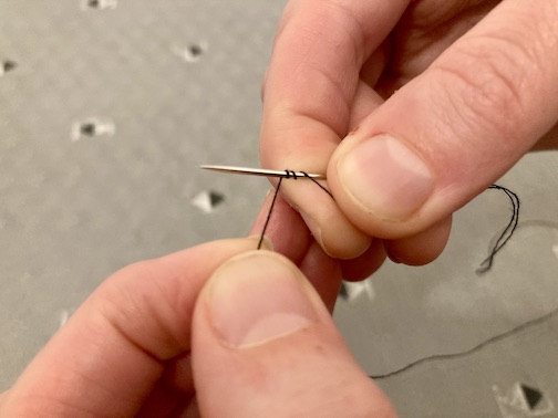 Wrapping the thread around the need three times