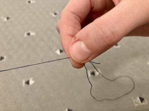 Pulling the three wraps of the thread down to the end of the thread