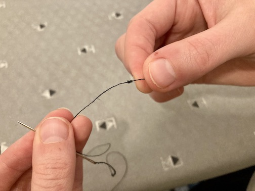 A knot at the end of the thread