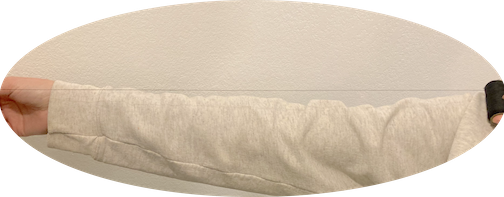 A person holding thread the length of their arm to measure the length of thread