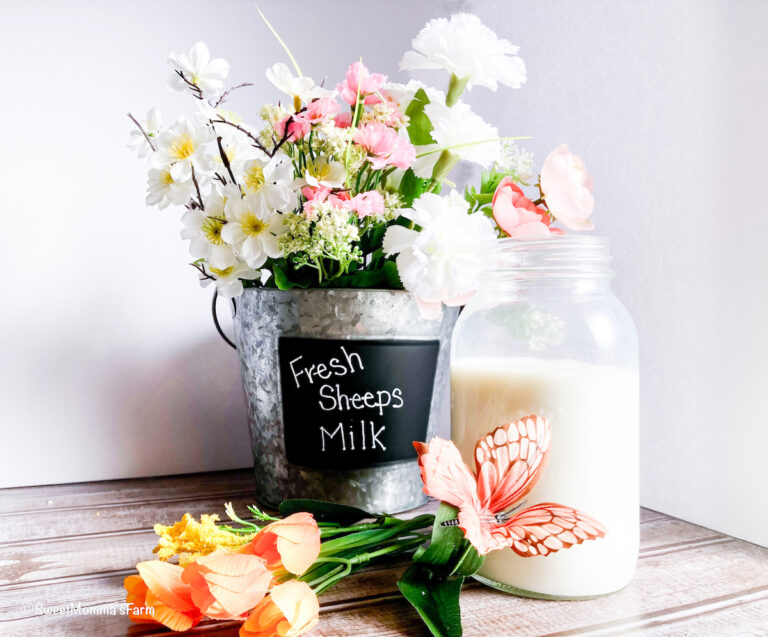 Bucket full of flowers with a mason jar full of fresh sheep's milk representing faith family and freedom