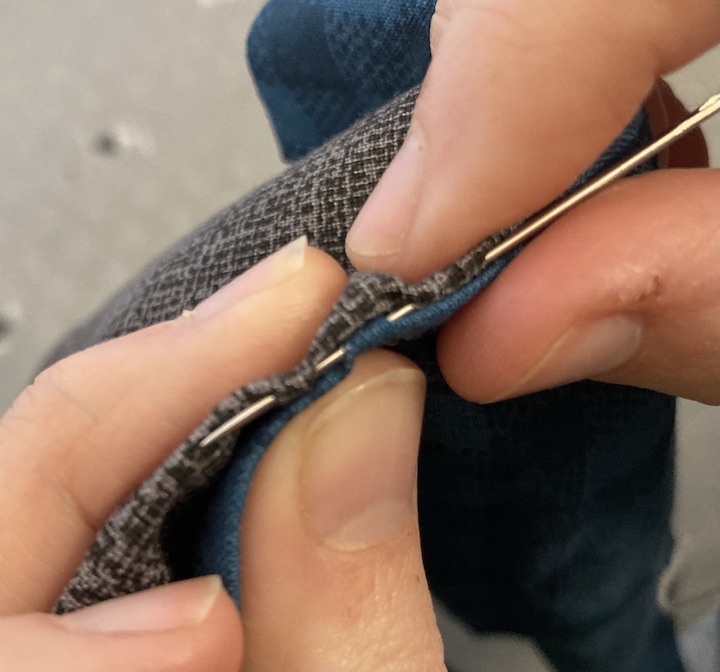 The needle being weaved through both tunnels
