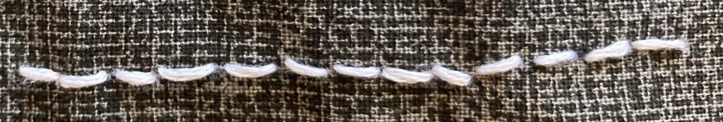 Close up a the basic hand stitch of the backstitch. How To Sew Basic Hand Stitches