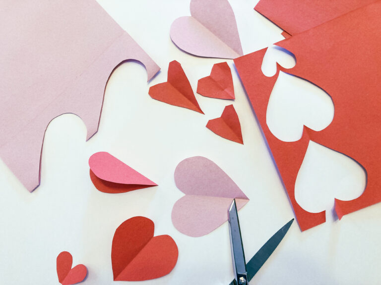 Cutting paper hearts for hearts of service