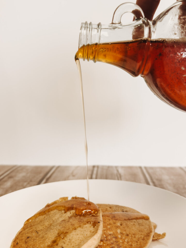 Honey Vanilla Pancake syrup being poured over pancakes